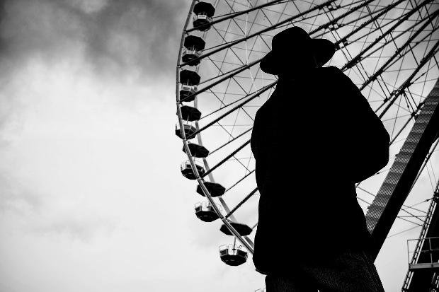 Silhouette of man and big wheel