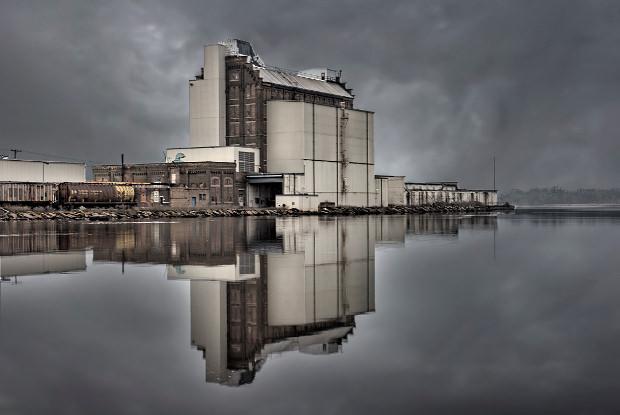 Industrial building reflected in water