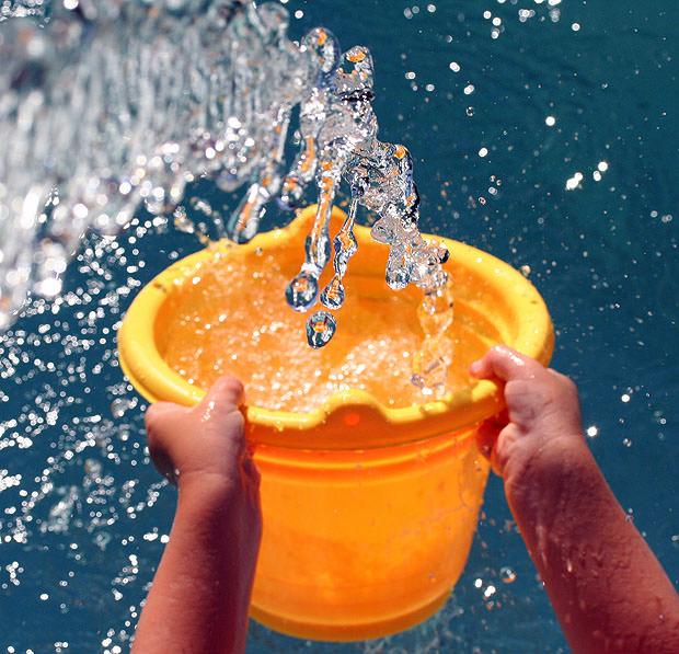 Water filling an orange bucket