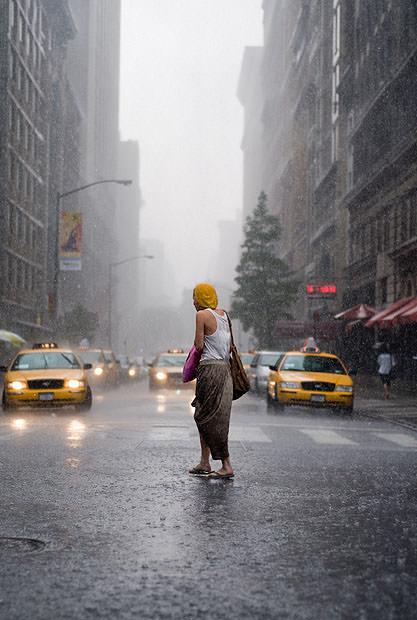 Woman crossing New York road in the rain