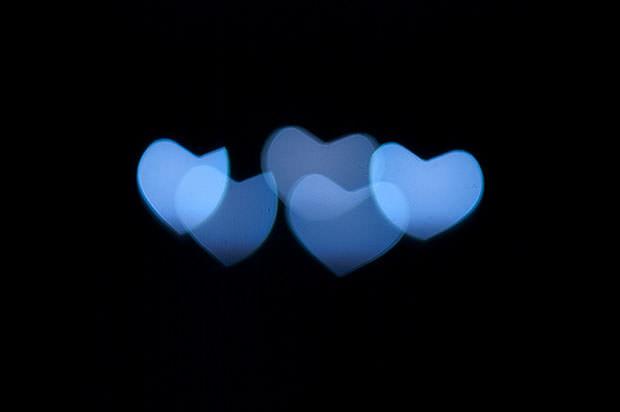 Blue heart bokeh on black