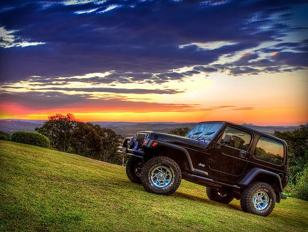 Jeep on a hill against the sunset