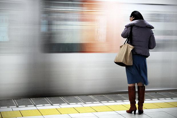 Woman framed against a train