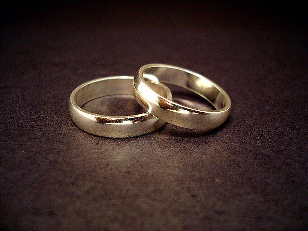 Pair of gold rings on a dark surface