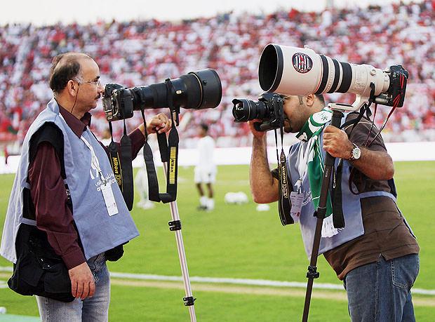 Sports photographers with monopods