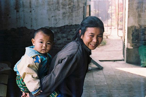 Chinese woman carrying her grandson