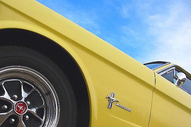Looking up at a yellow Ford Mustang